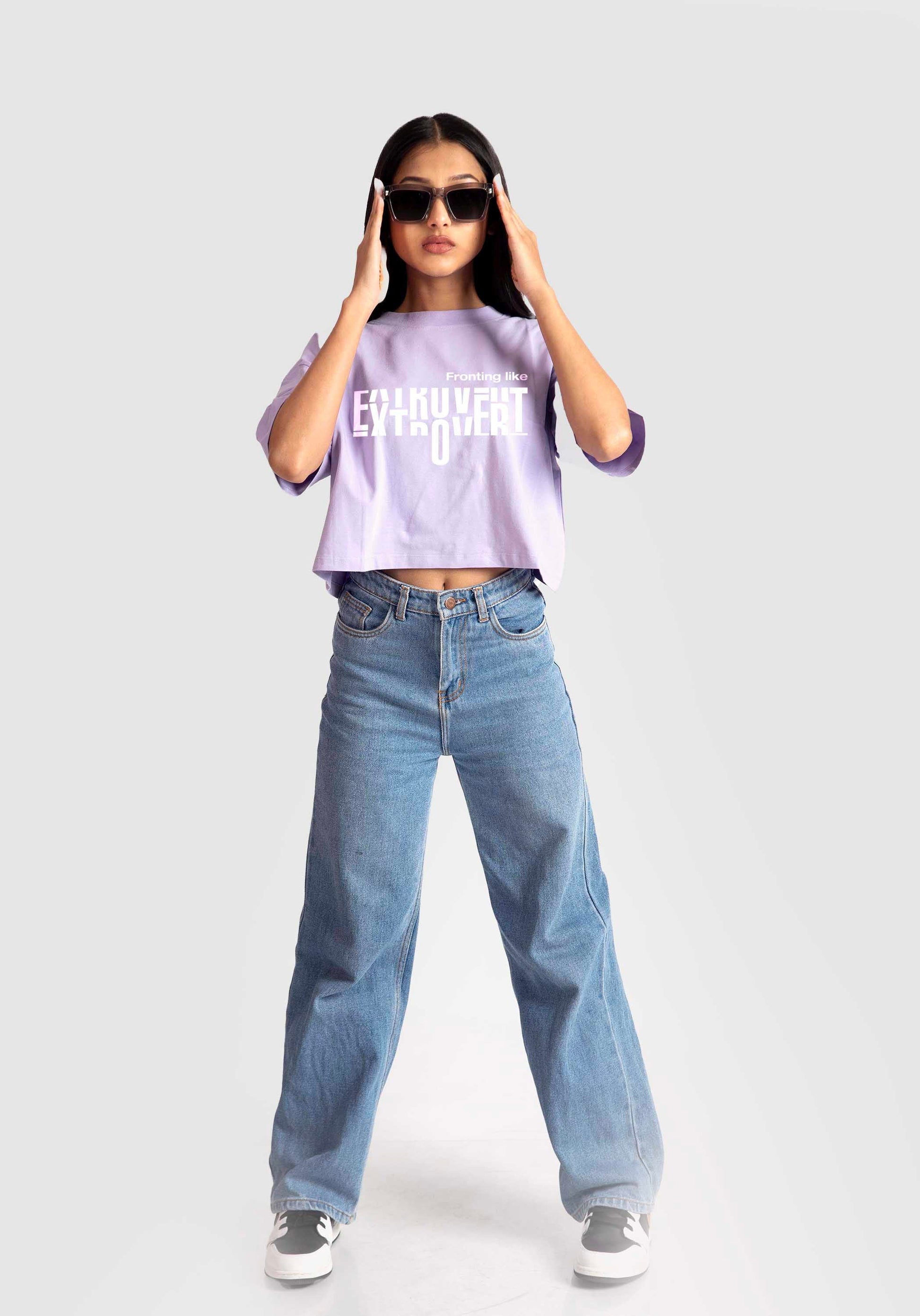 Stylera lavender oversized crop top worn by model with casual blue jeans and sunglasses