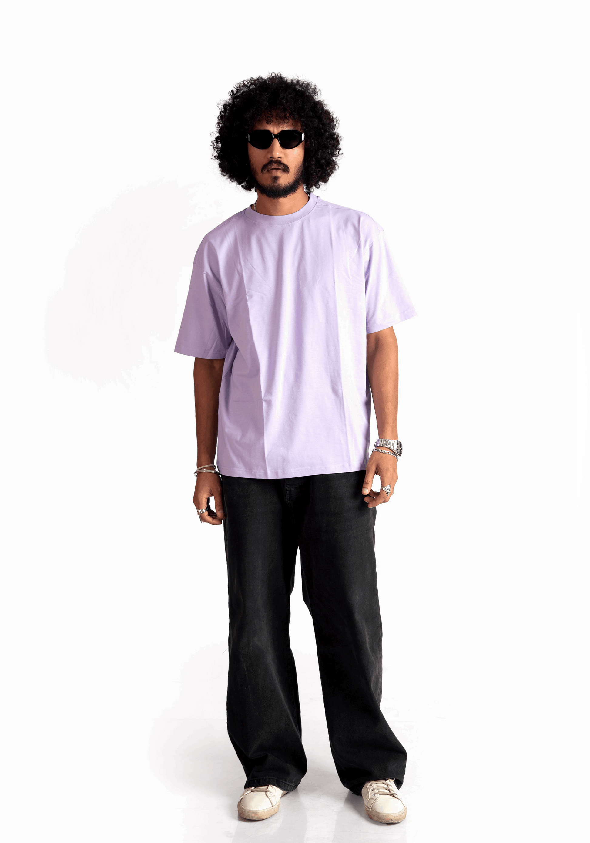 Man wearing Stylera lavender oversized t-shirt paired with black pants and sunglasses