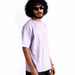 Man wearing Stylera lavender oversized t-shirt with black shorts and sunglasses