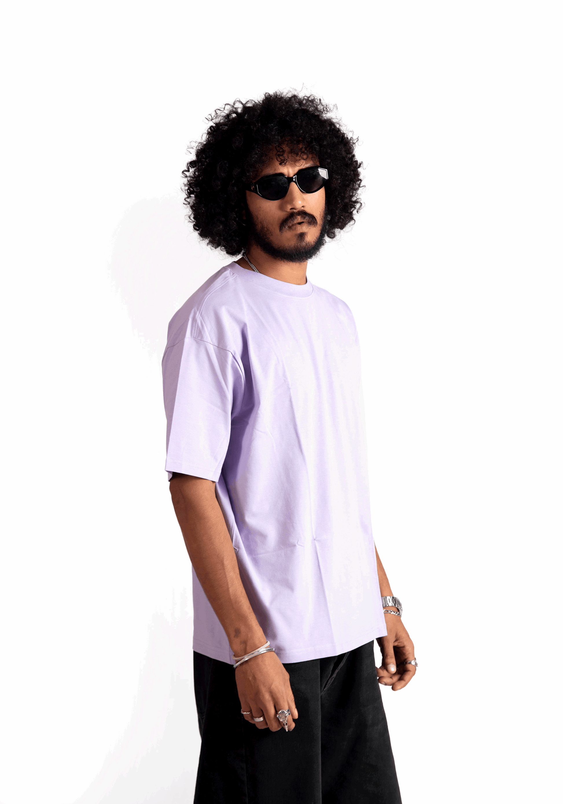 Man wearing Stylera lavender oversized t-shirt with black shorts and sunglasses