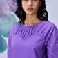Model wearing Stylera lavender regular fit top with scoop neckline and short sleeves