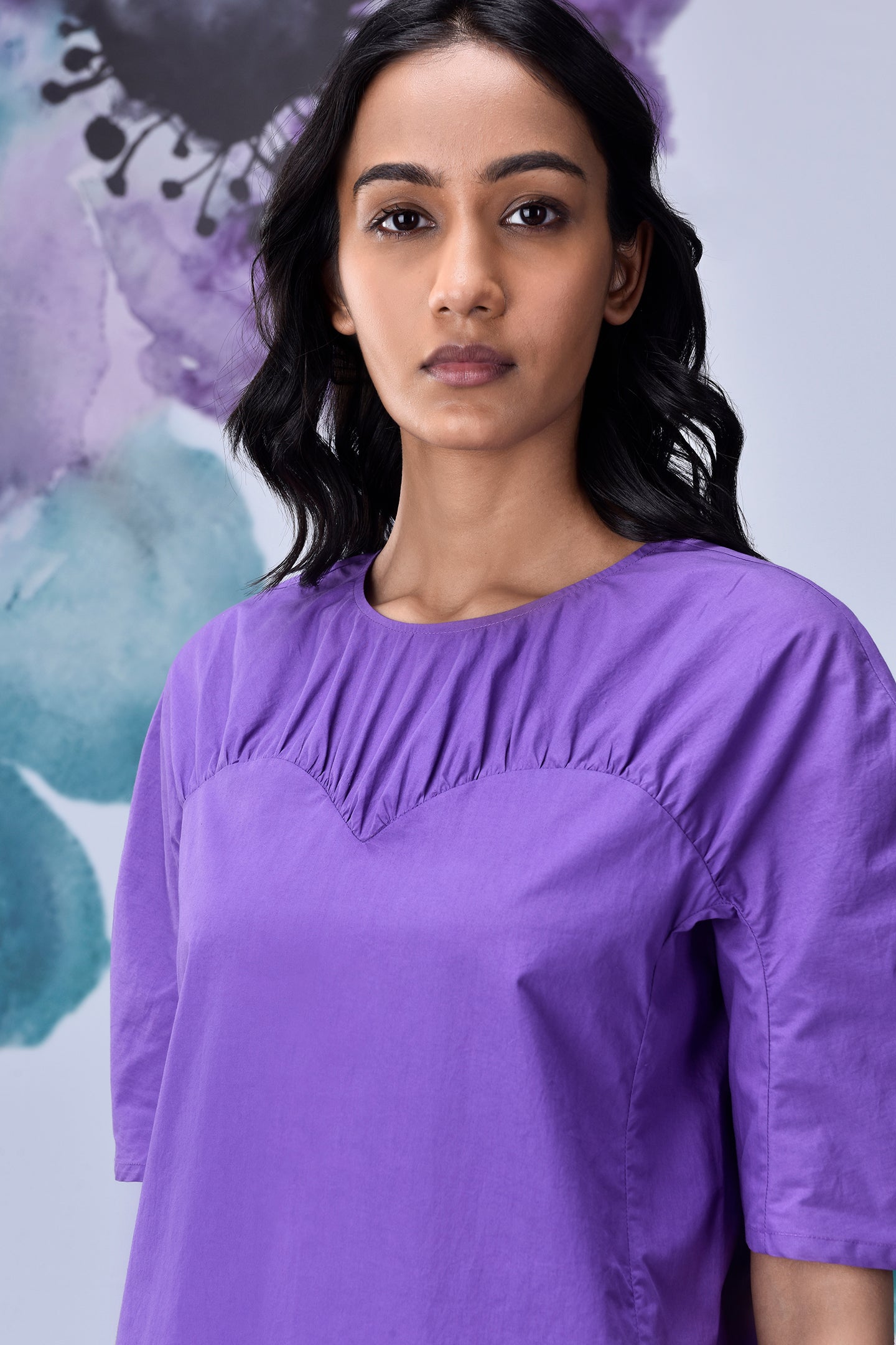 Model wearing Stylera lavender regular fit top with scoop neckline and short sleeves