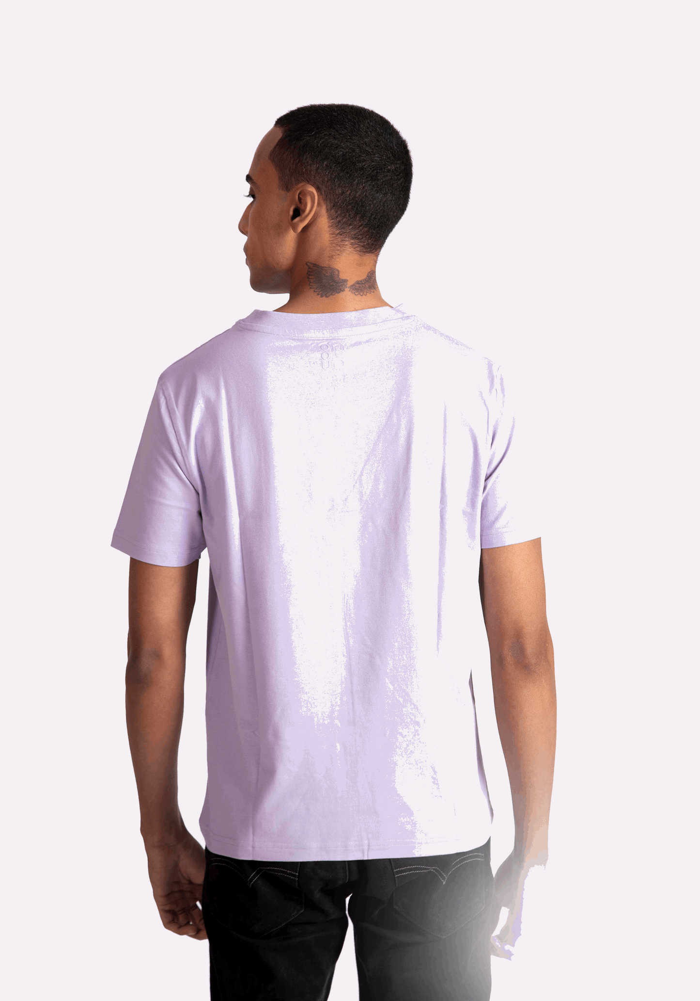 Back view of a man wearing a lavender t-shirt for men by Stylera paired with black pants