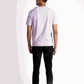 Back view of a man wearing a lavender t-shirt for men paired with black pants and white sneakers