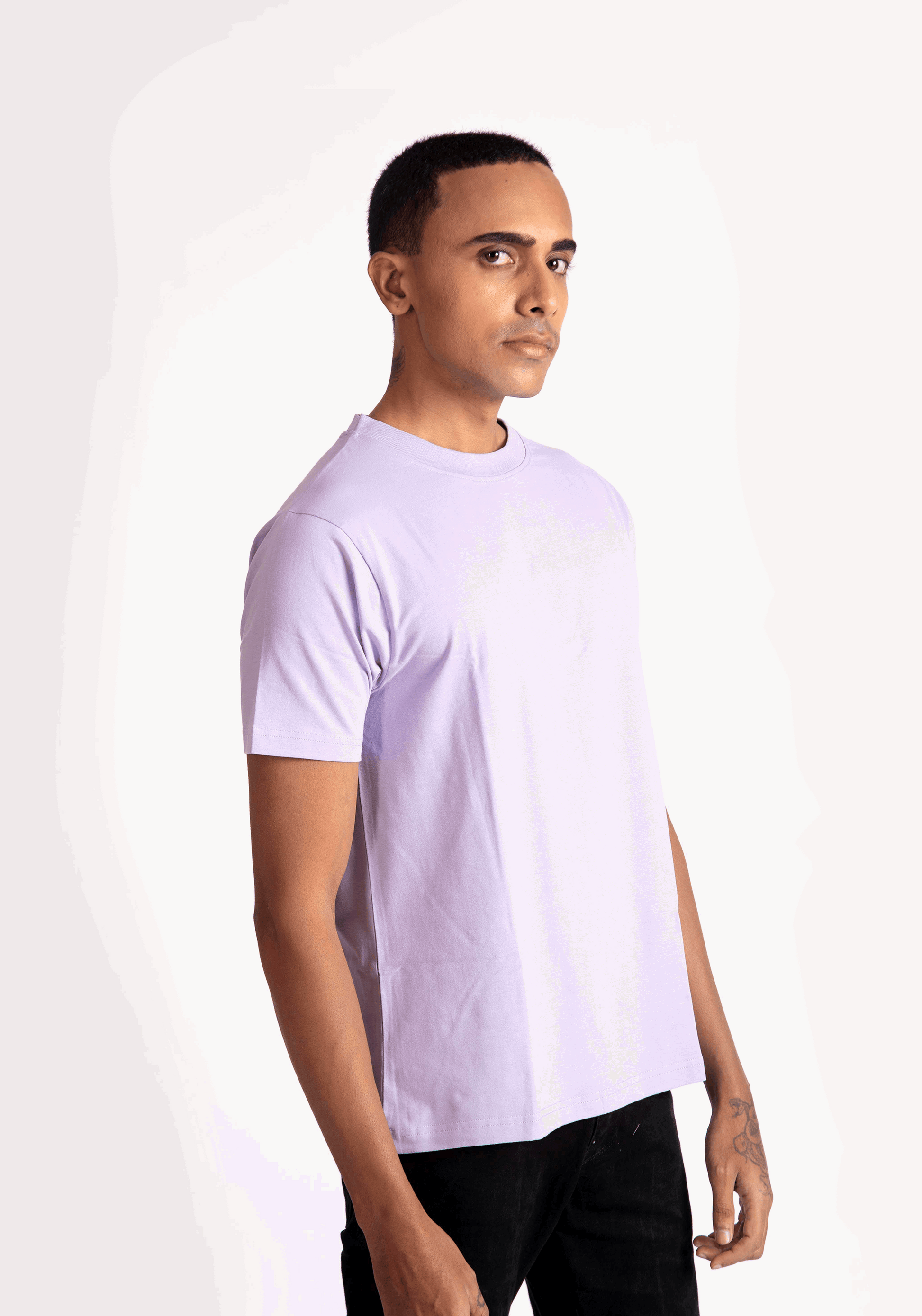 Stylera lavender t-shirt for men worn by model in casual black pants on white background