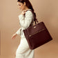 Stylish Aspire leather work tote with zipper, carried by a woman in a chic outfit for a polished look