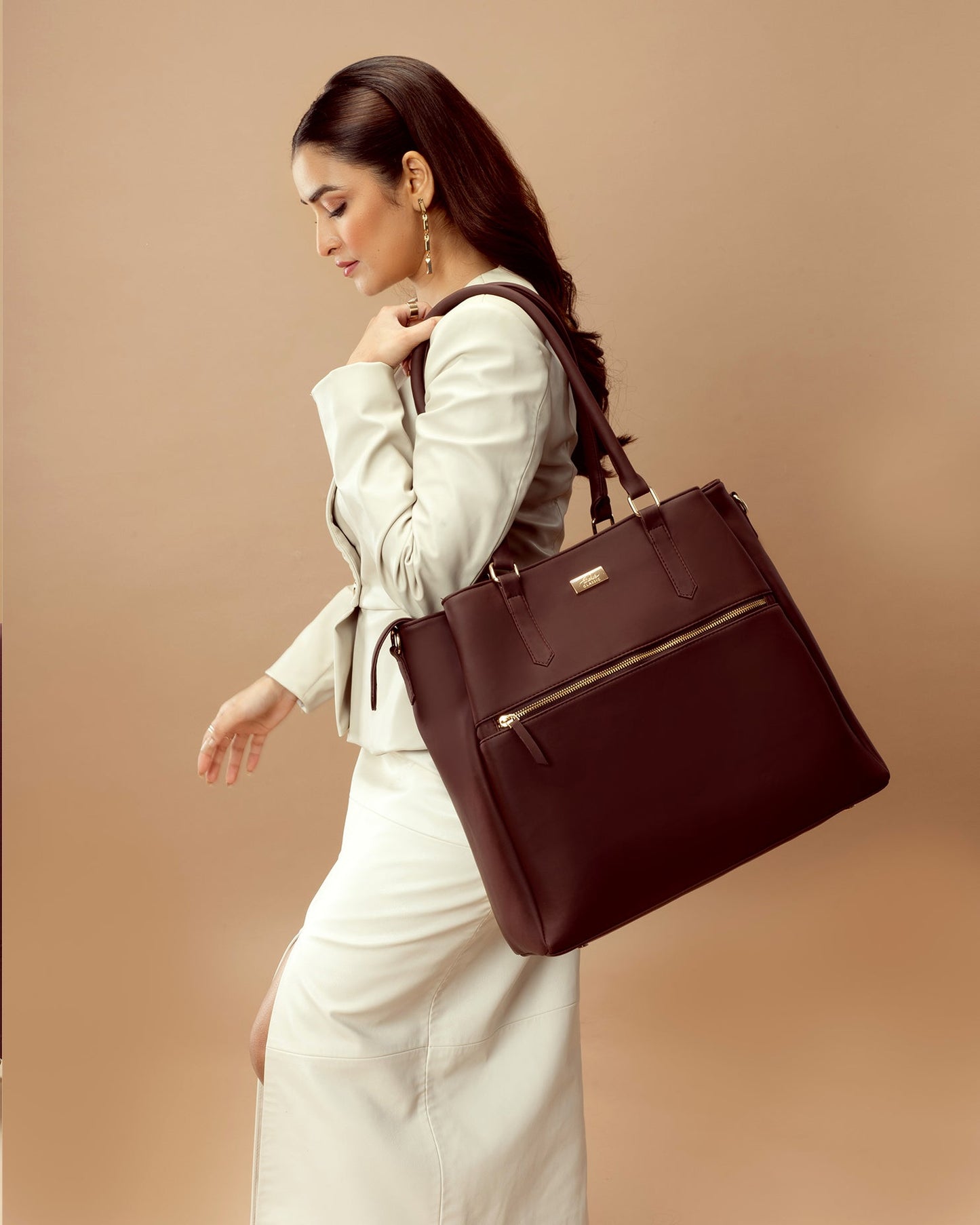 Stylish Aspire leather work tote with zipper, carried by a woman in a chic outfit for a polished look