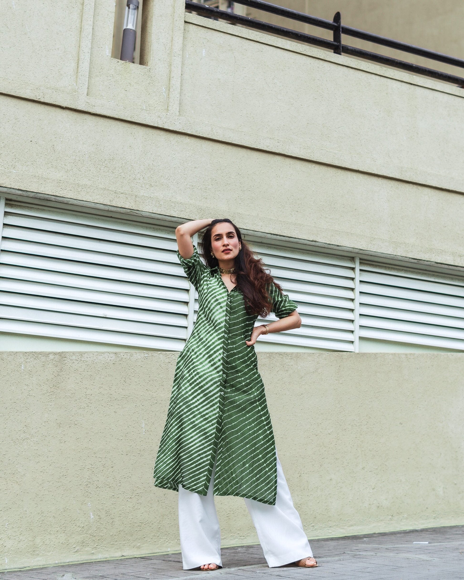 Stylish green Lehriya kurti for women paired with white palazzo pants, perfect for casual outings