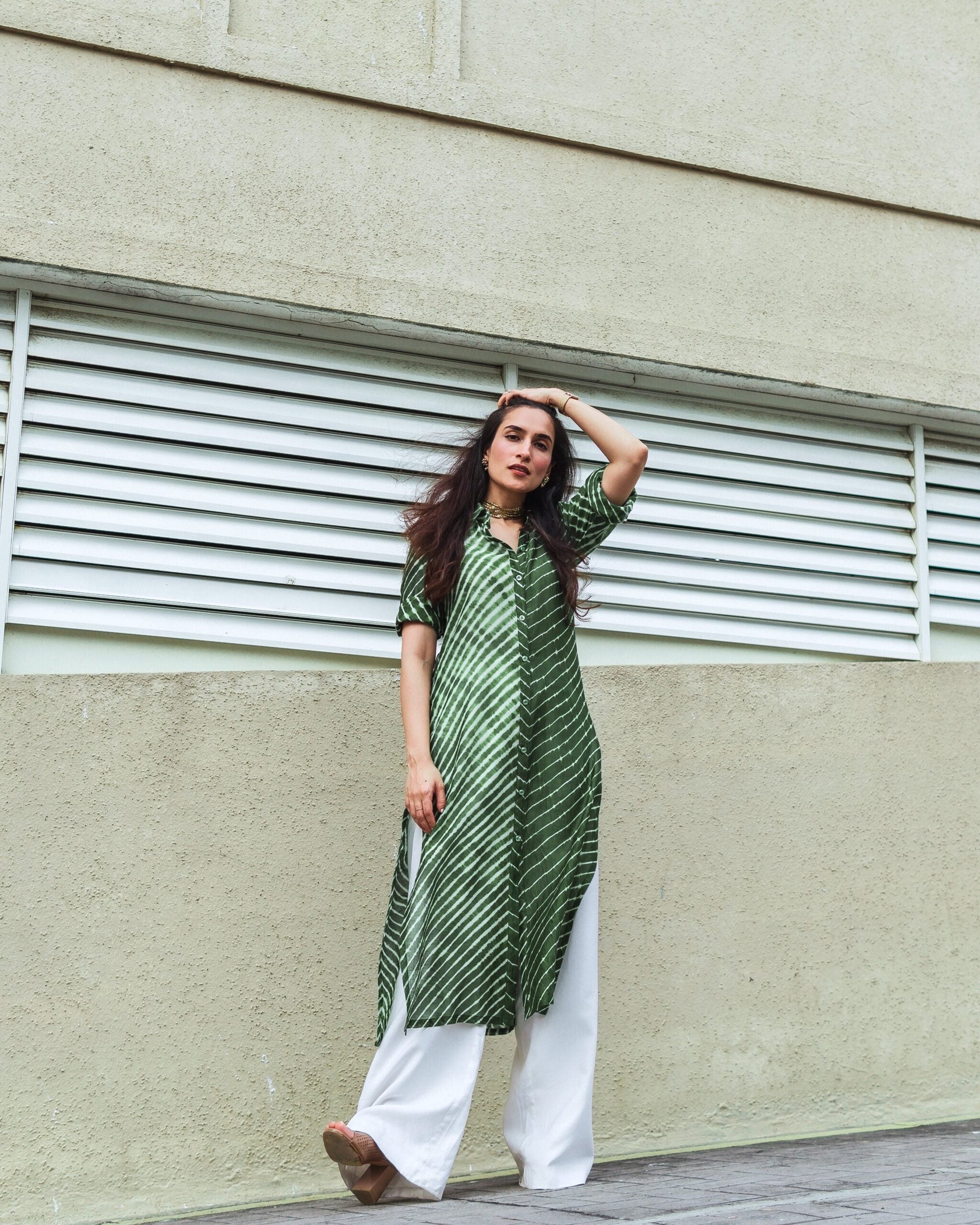 Elegant green Lehriya kurti for women with stripes, paired with white palazzo pants, perfect for casual outings