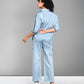 Model wearing a light blue denim matching set featuring a stylish top and relaxed pants