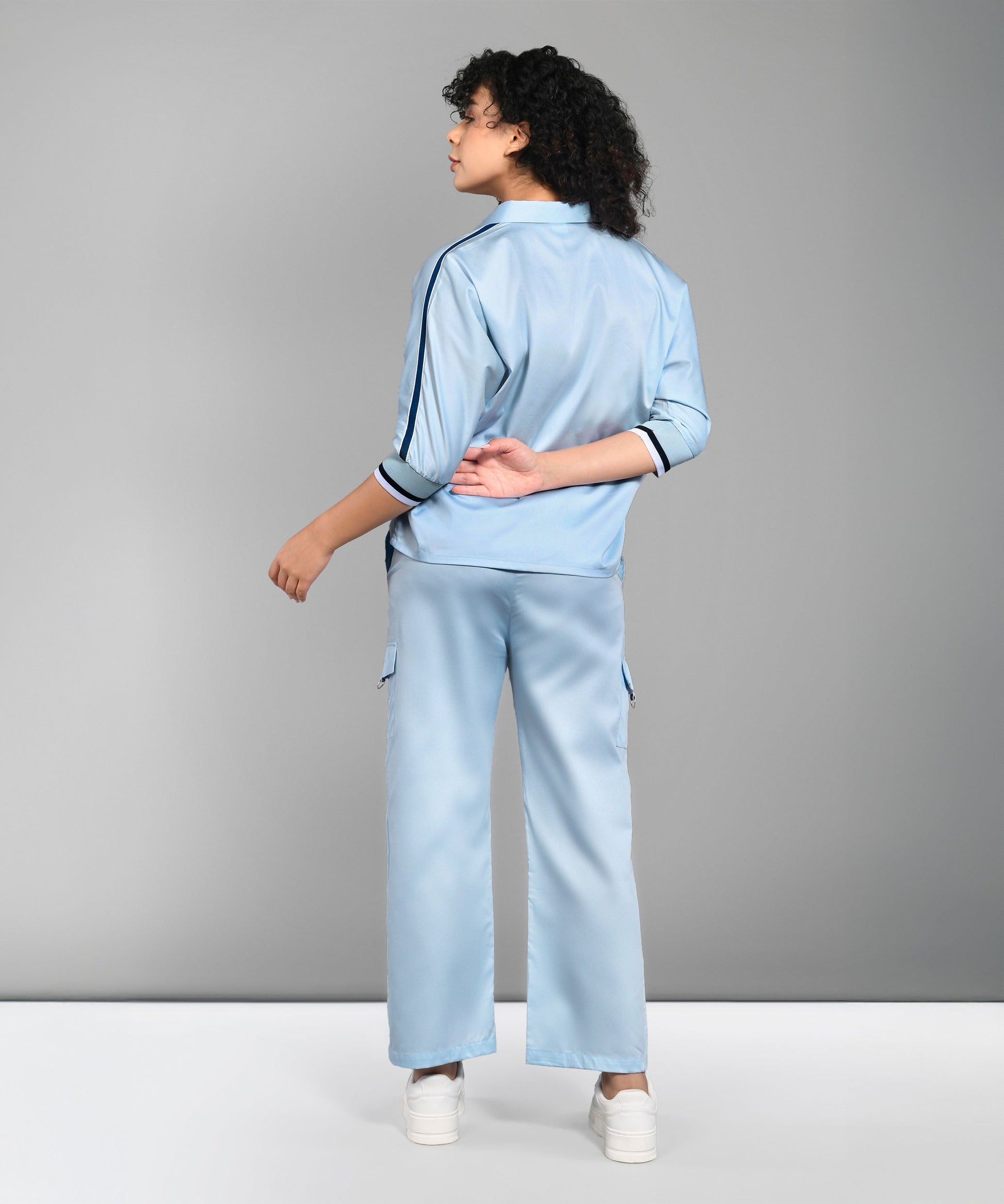 Model wearing a light blue denim matching set featuring a stylish top and relaxed pants