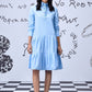 Stylera light blue sequin dress with long sleeves tiered skirt button placket on model