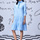 Stylera light blue sequin dress styled as a long sleeve shirt dress with pleated tiers
