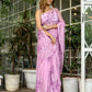 Elegant light pink floral saree with intricate purple embroidery, perfect for special occasions