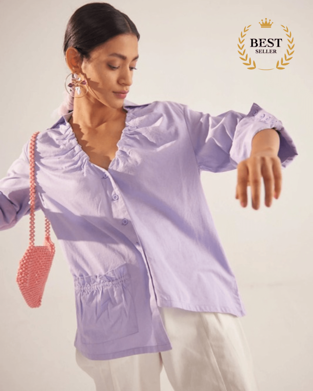 Stylera light purple fashion top with ruffle details and front pockets worn by woman