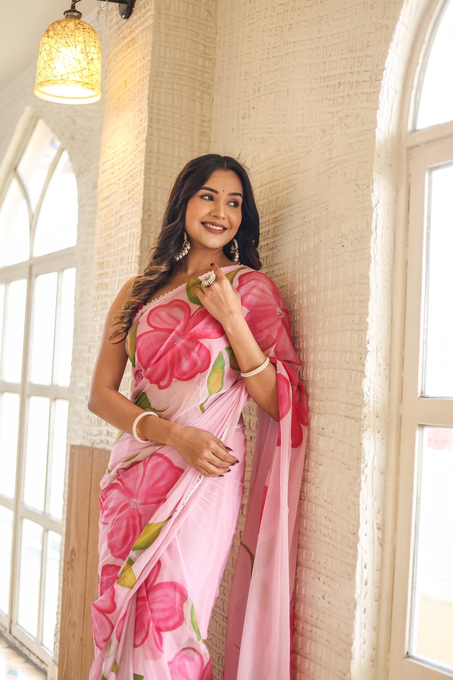 Elegant lightweight party wear saree in pink with floral patterns, perfect for festive occasions