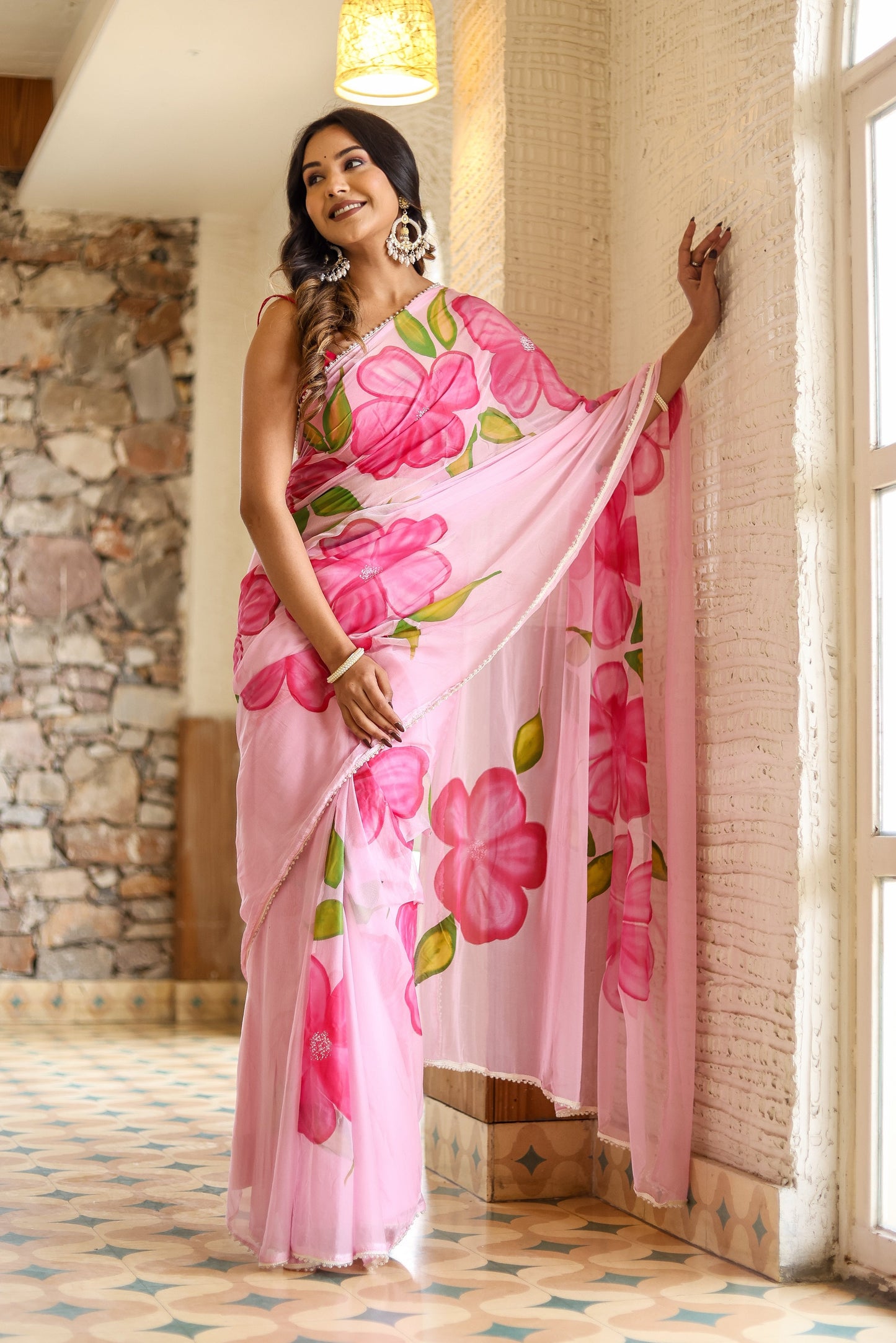 Elegant lightweight party wear saree in pink with floral patterns, perfect for special occasions