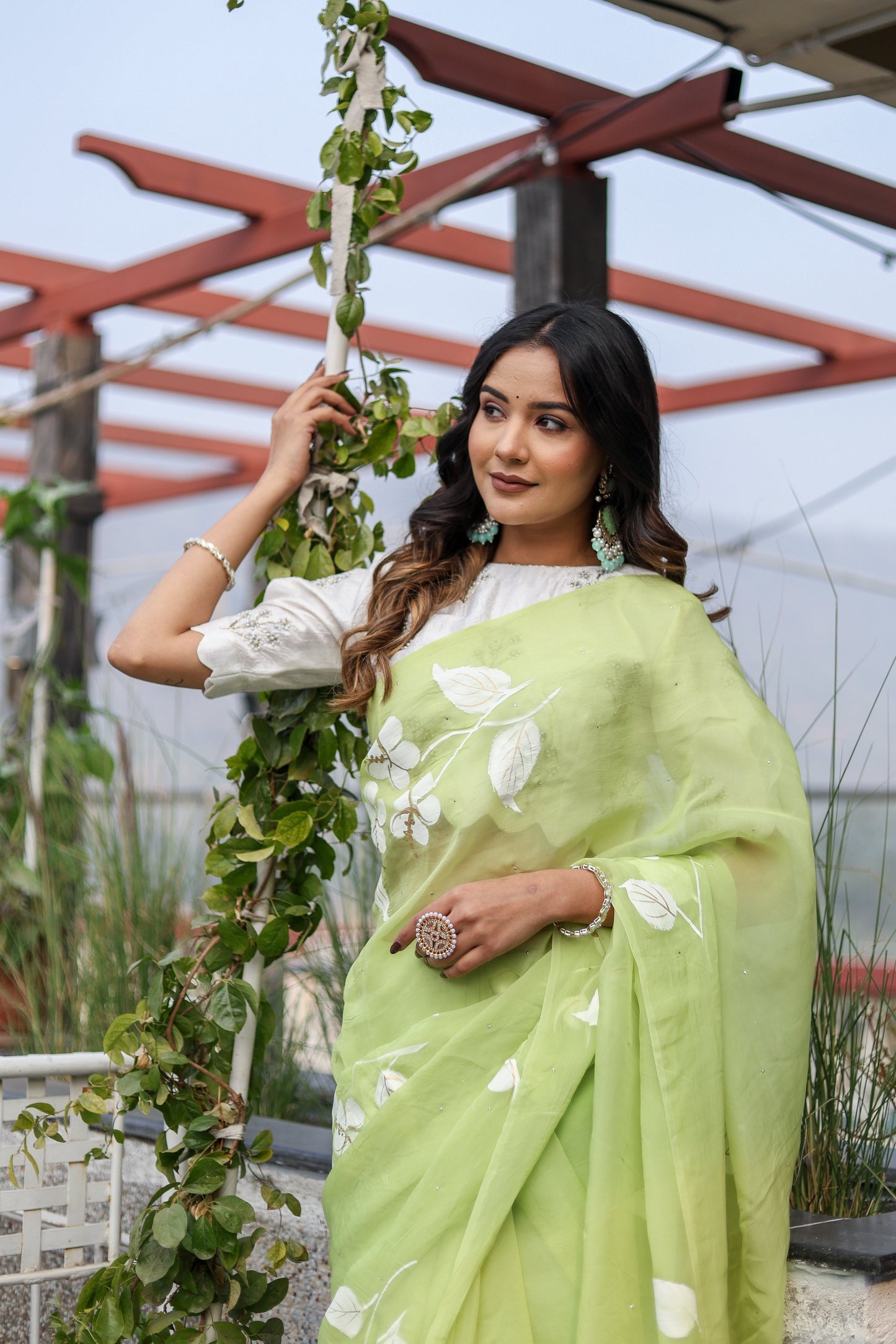Elegant lightweight party wear saree in soft green with floral embroidery, perfect for festive occasions