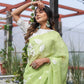 Lightweight party wear saree in soft green, adorned with floral patterns, perfect for festive occasions