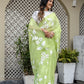 Lightweight party wear saree in green with floral embroidery, complemented by a stylish blouse