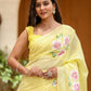 Model wearing a lightweight party wear saree in yellow with floral designs and elegant accessories