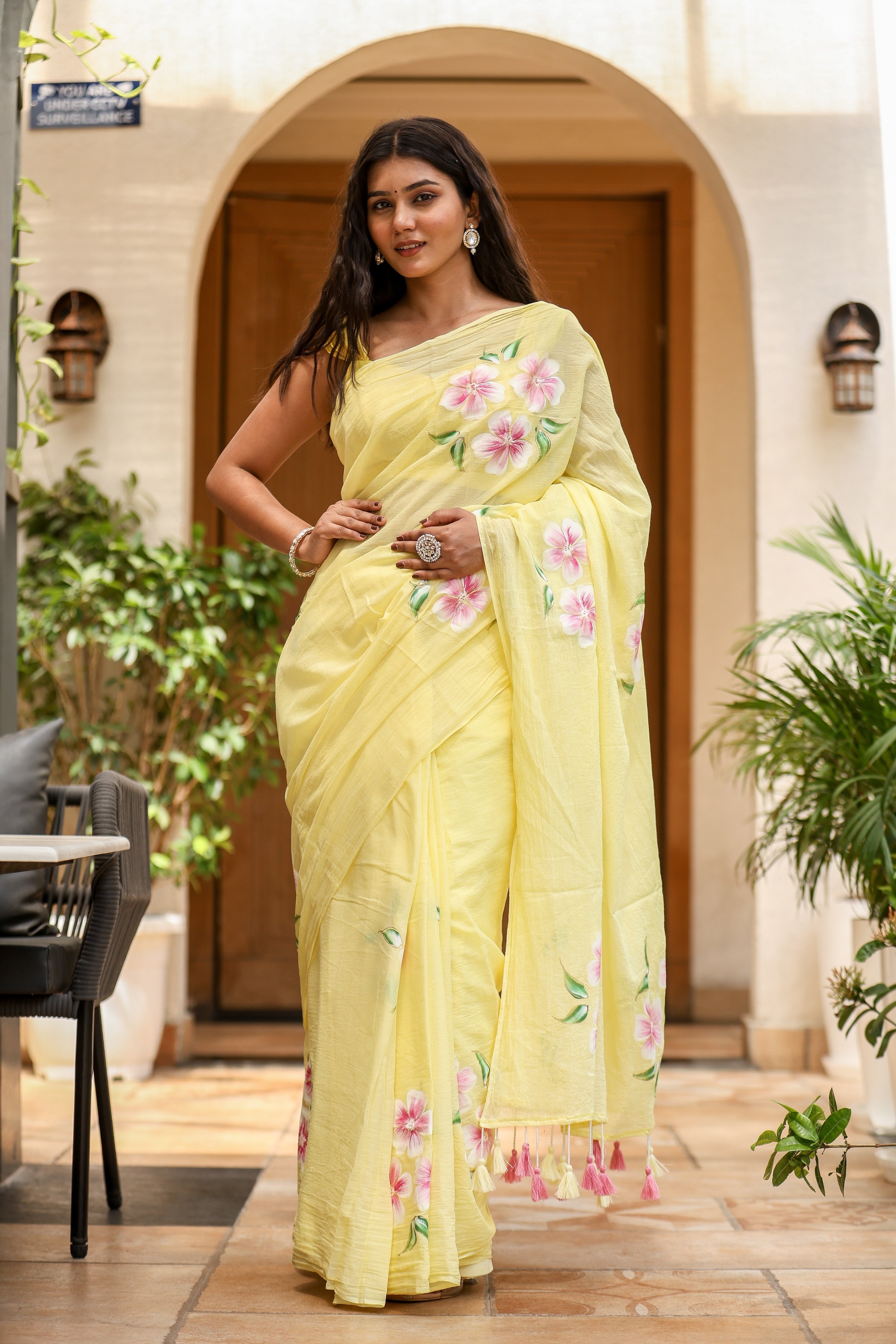 Elegant lightweight party wear saree in yellow with floral patterns and tassels for festive occasions