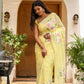 Elegant lightweight party wear saree in yellow with floral details, perfect for festive occasions.
