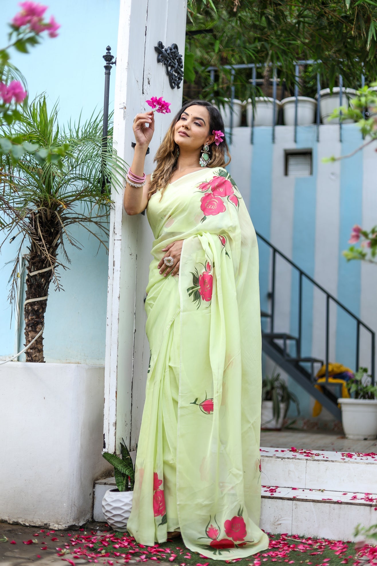 Elegant model wearing a lightweight pastel saree with floral print, showcasing vibrant floral details