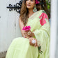 Elegant model wearing a lightweight pastel saree with floral print, styled with floral accessories