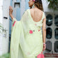 Stylish woman wearing a lightweight pastel saree with floral print in a serene outdoor setting