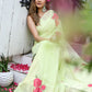 Model wearing a lightweight pastel saree with floral print, styled elegantly with floral accessories