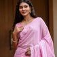 Beautiful woman wearing a lightweight summer saree for women in pastel pink with floral designs