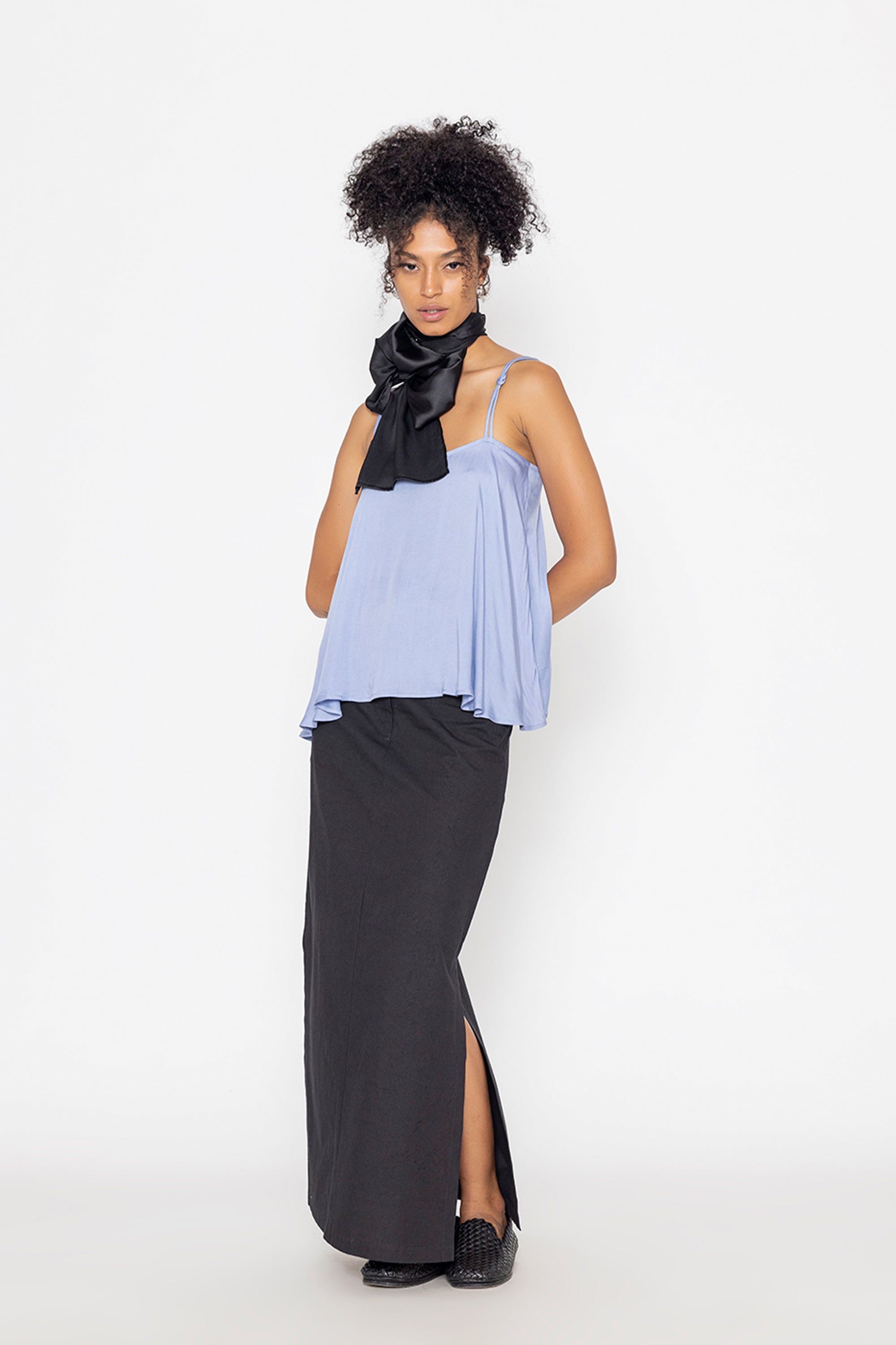 Stylera long black skirt with slit styled with light blue top and black neck scarf