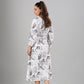 Stylera model wearing long sleeve casual midi dress white with black sketch print belted waist back view