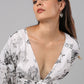 Model wearing Stylera long sleeve casual midi dress in white with black sketch print deep V tie front