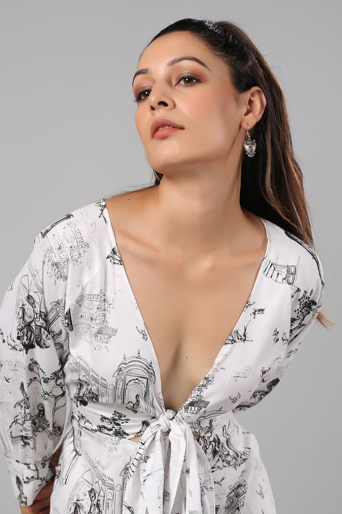 Model wearing Stylera long sleeve casual midi dress in white with black sketch print deep V tie front