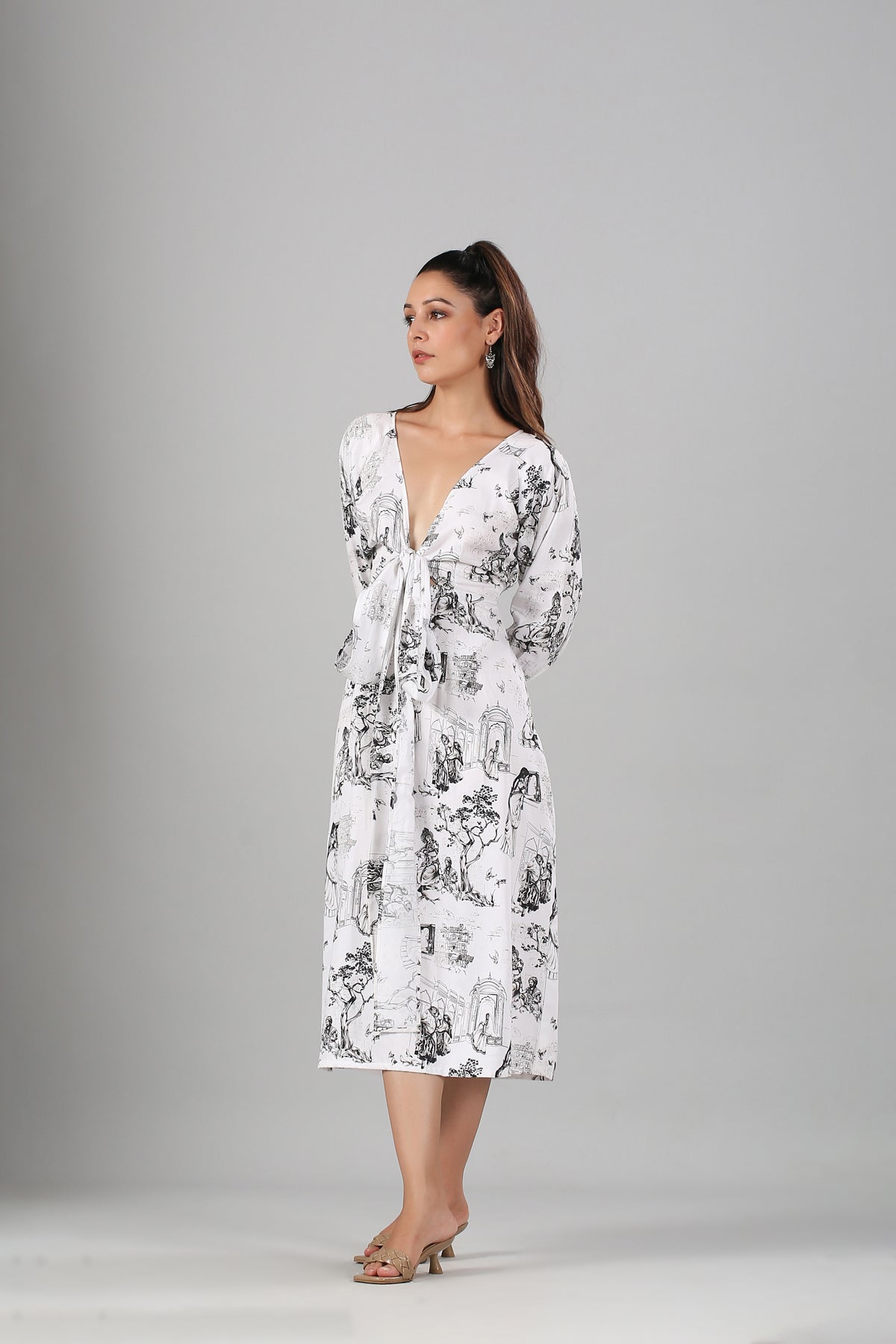 Stylera long sleeve casual midi dress white toile print with tie waist and deep V neckline on model