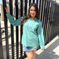 Stylera long sleeve lightweight top for women in teal paired with a denim skirt for a casual look