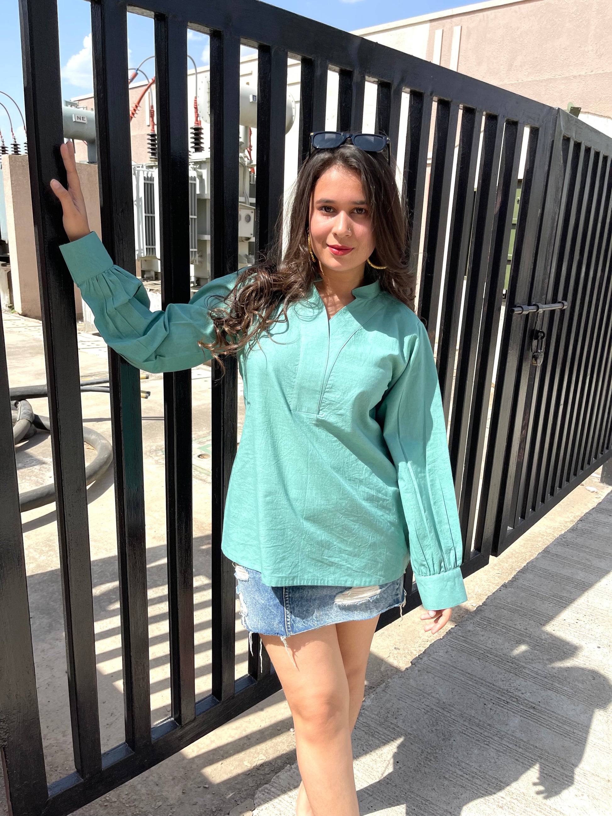 Stylera long sleeve lightweight top for women in teal paired with a denim skirt for a casual look