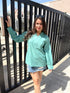 Stylera long sleeve lightweight top for women in teal paired with a denim skirt for a casual look