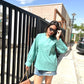 Woman wearing a long sleeve lightweight top for women in turquoise with relaxed fit and stylish sunglasses