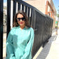 Stylera long sleeve lightweight top for women in teal, styled with sunglasses and casual shorts
