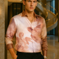 Model wearing Stylera luxury art print men's shirt with classical angel painting design in upscale hotel lobby