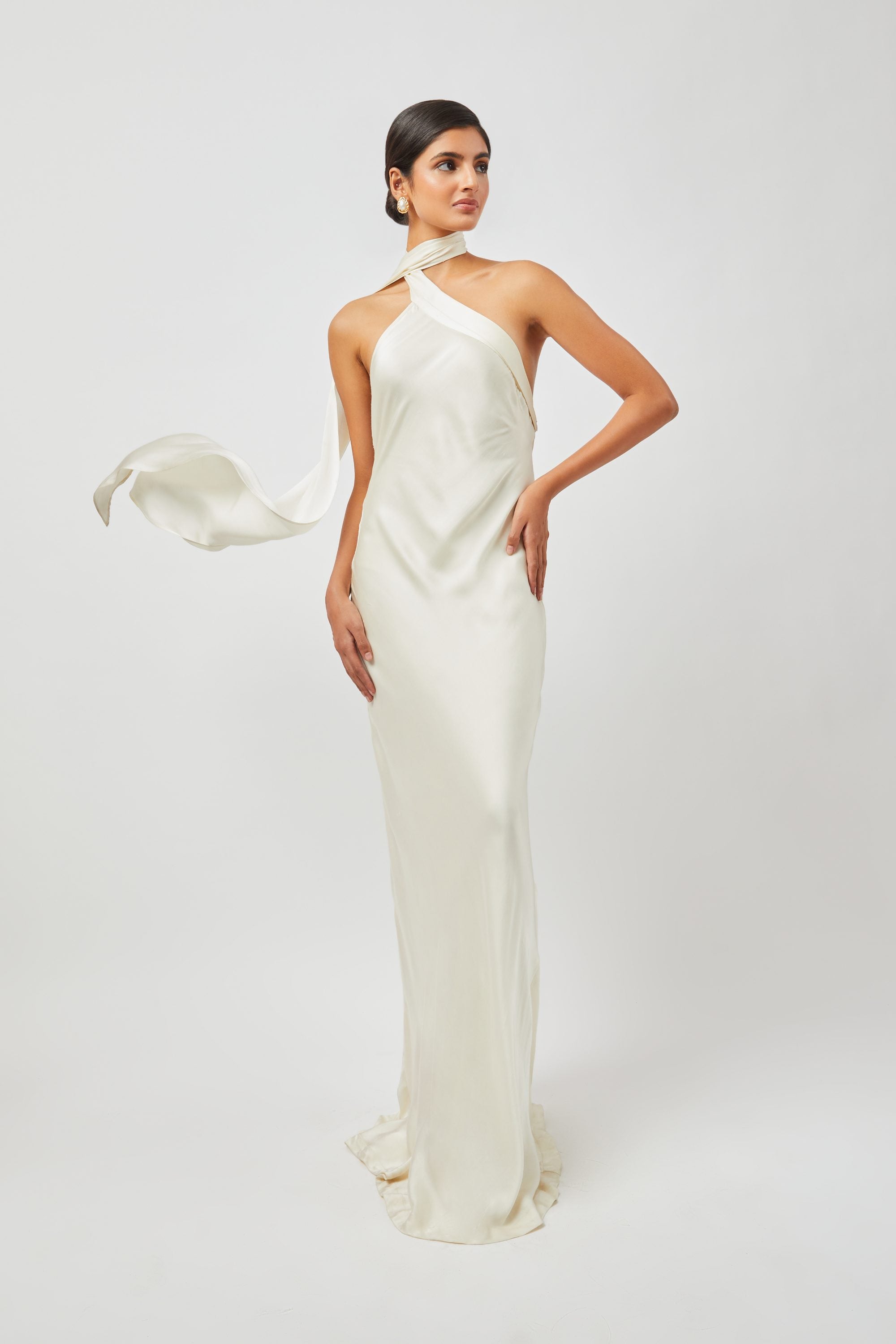 Stylera luxury long gown in ivory with a halter neck and flowing scarf detail