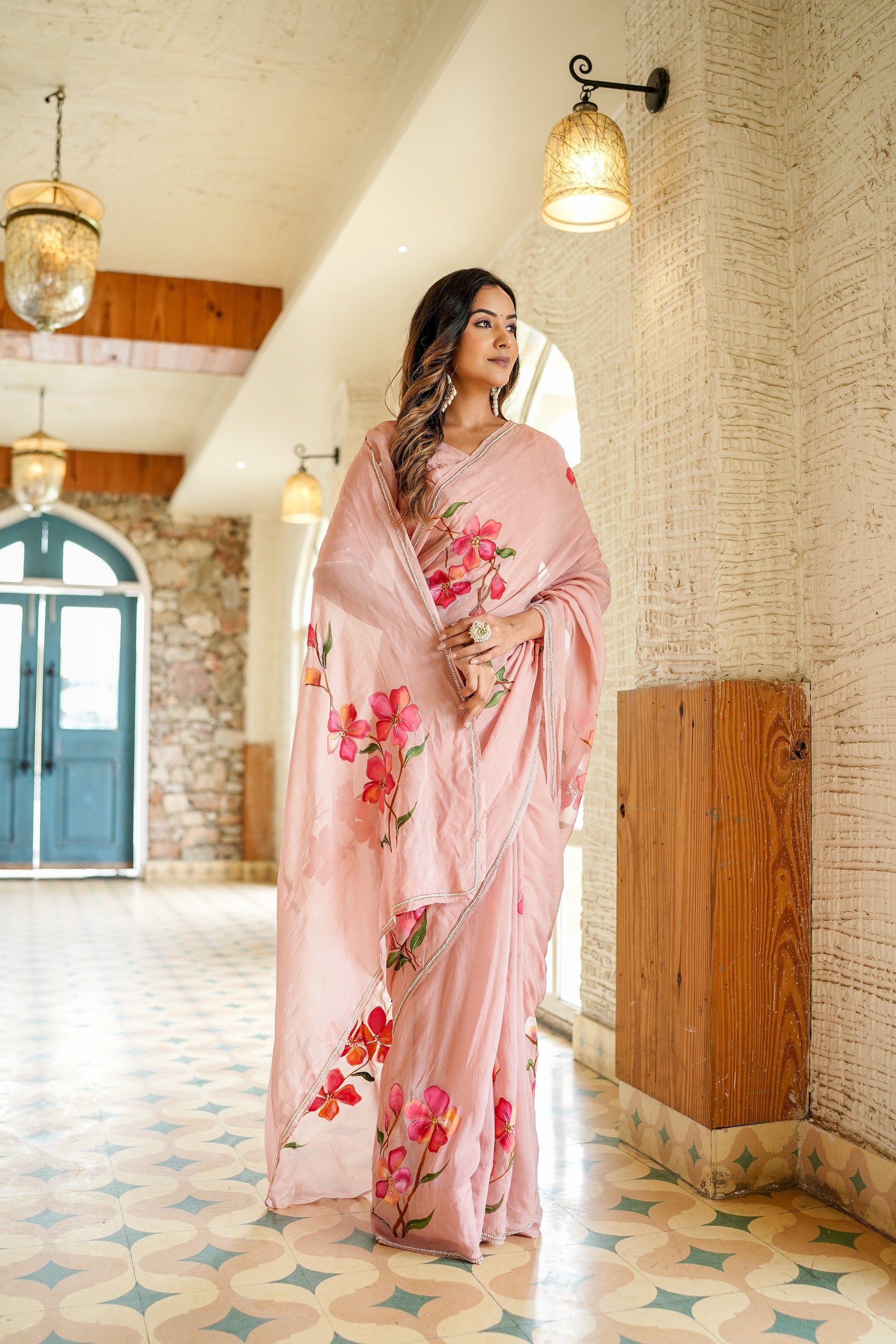 Elegant luxury statement saree for special occasions in soft pink with floral embroidery