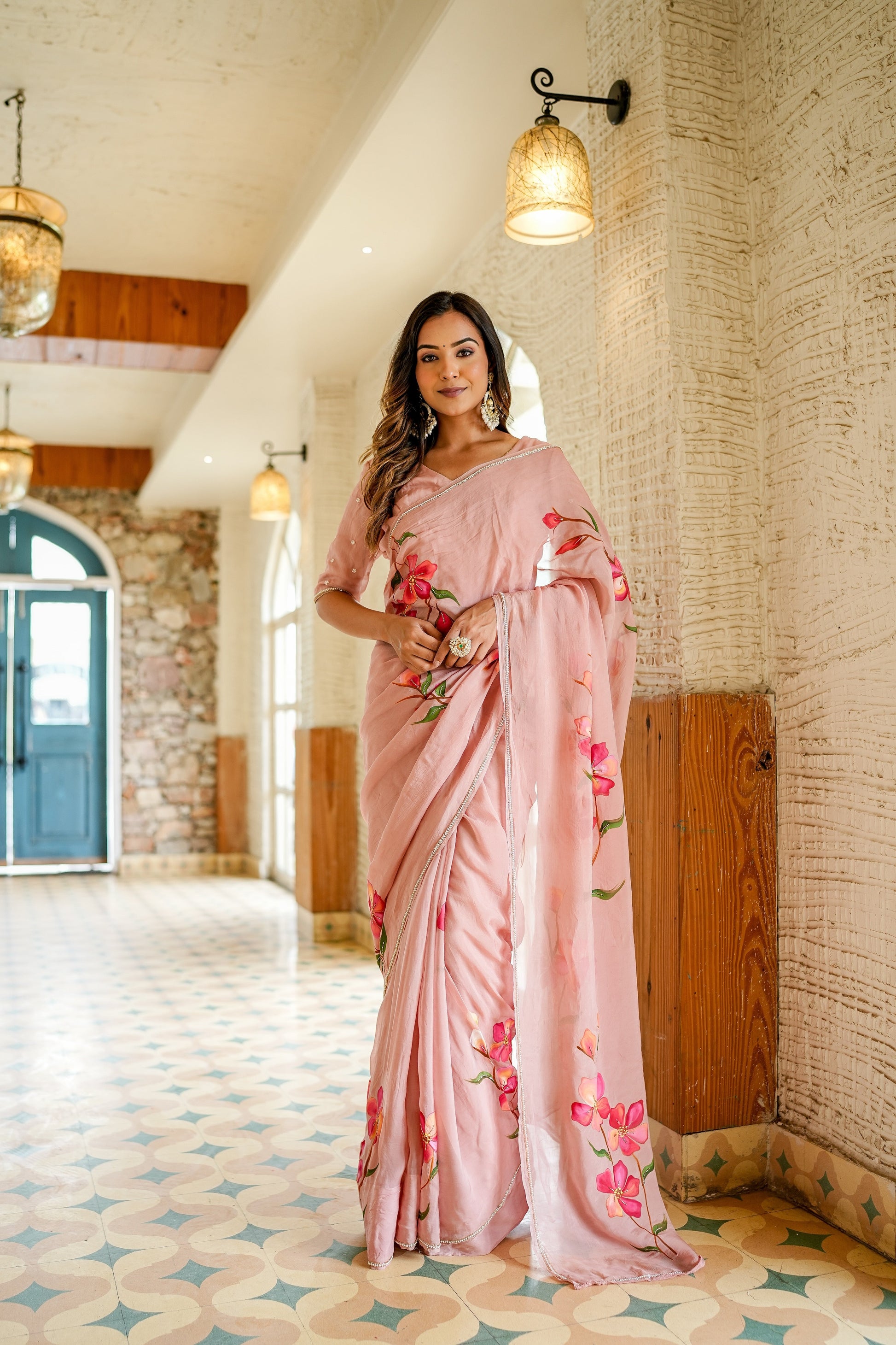 Elegant woman wearing a luxury statement saree for special occasions with floral embroidery