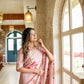 Elegant woman in a pink luxury statement saree for special occasions, featuring floral embroidery
