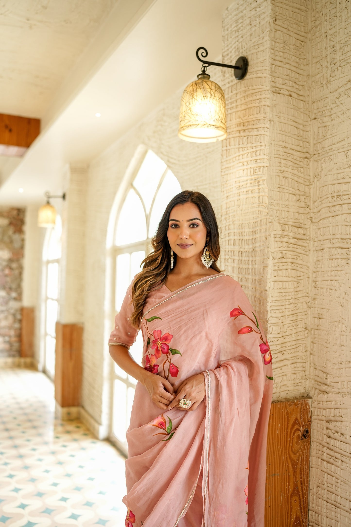 Elegant pink luxury statement saree for special occasions featuring floral embroidery and a stylish drape