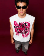 Person wearing a sleeveless shirt with a bold graphic and text on a dark background