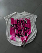 Gray t-shirt with pink and black text on a gray floor